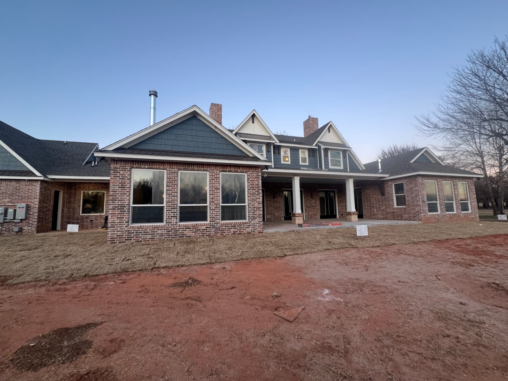 full rear exterior of a custom brick and siding home painted in the OKC metro